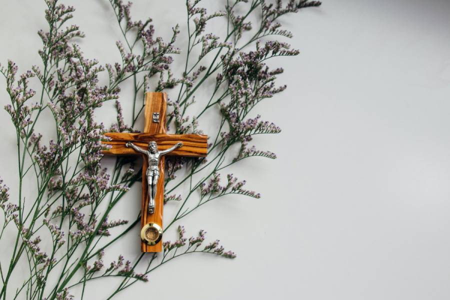 Brown crucifix over a branch
