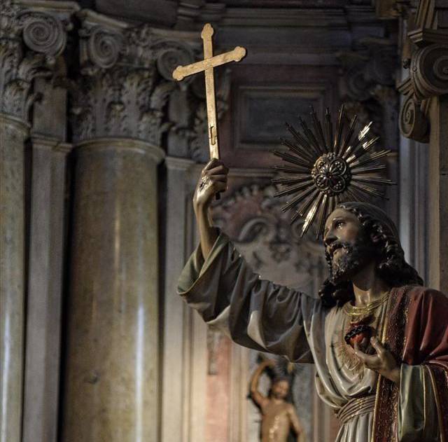 Statue of Jesus holding cross and sacred heart